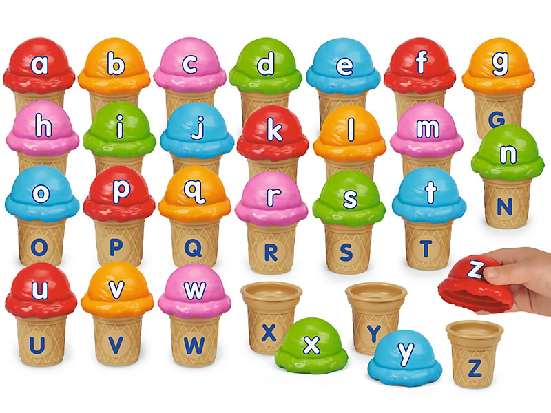 Colorful ice cream cone toys with letters A-Z. Cones feature vibrant scoops, each showing a letter. A hand lifts the red scoop with letter Z.