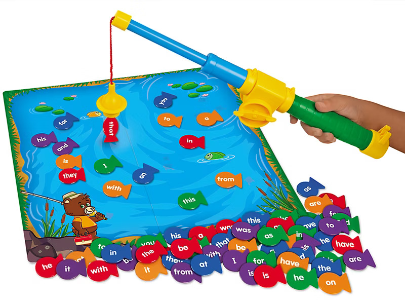 A colorful fishing game for kids features a blue pond with word-labeled fish pieces.