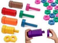 Colorful plastic toy nuts and bolts are arranged by color: red, orange, yellow, brown, green, blue, purple, and pink. A child assembles a purple bolt.