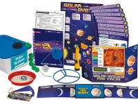 Solar system educational kit with books, charts, models, and moon phases wheel on a white surface.