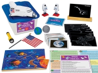 Space-themed educational kit with a labeled box, miniature space shuttle, astronaut figures, constellation cards, planets, flag, and flashlight. 