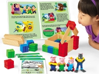 A child in a purple shirt playfully blows on a model house built from wooden and colorful blocks. Toy figures of the Three Little Pigs and the wolf stand beside the house.